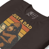 Bigfoot-themed dad T-shirt featuring a sun-glassed Sasquatch with milk carton and retro rainbow design.
