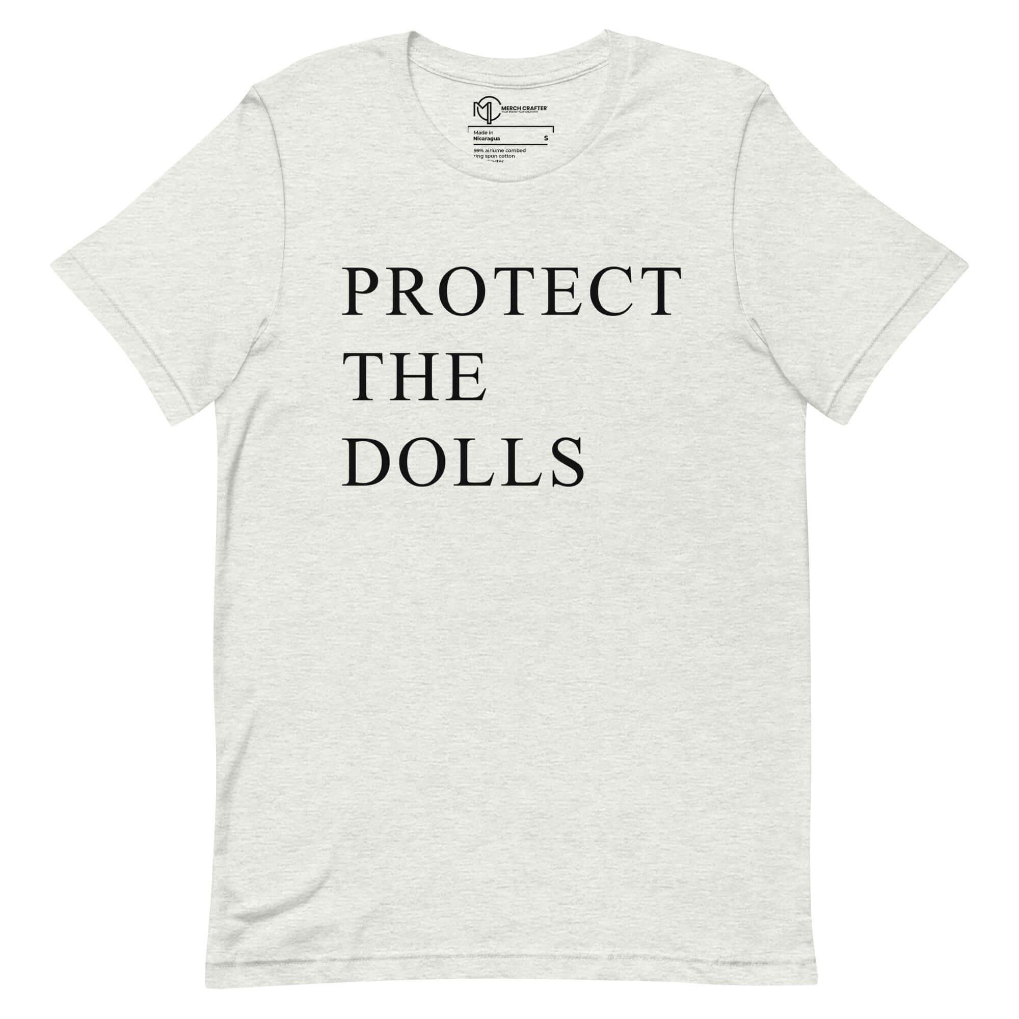 Protect the Dolls unisex t-shirt featuring bold text promoting femininity and girlhood.