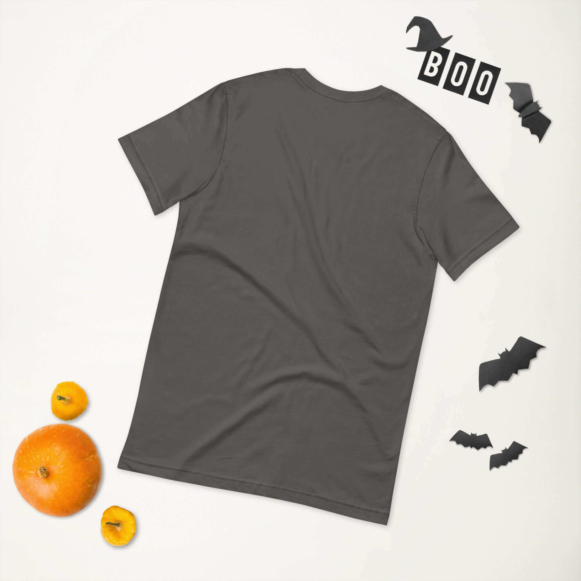 Back view of a grey unisex t-shirt on a white background with Halloween decorations including bats, "BOO" letters, and pumpkins.