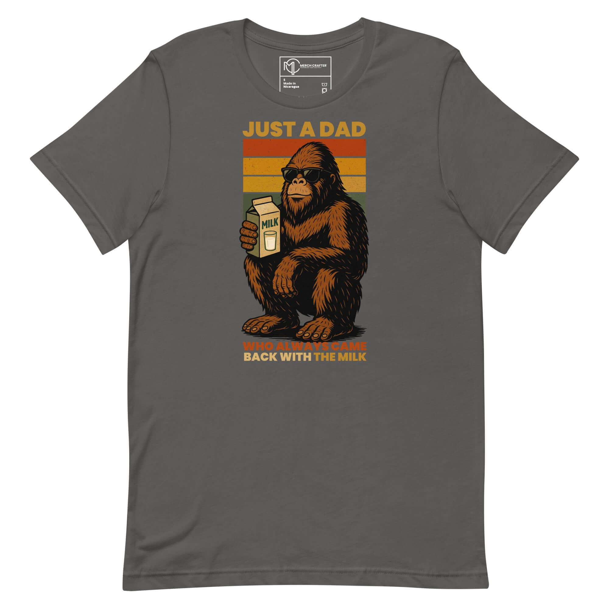Just a Dad Bigfoot t-shirt featuring a Sasquatch holding milk, with a vintage rainbow stripe design.