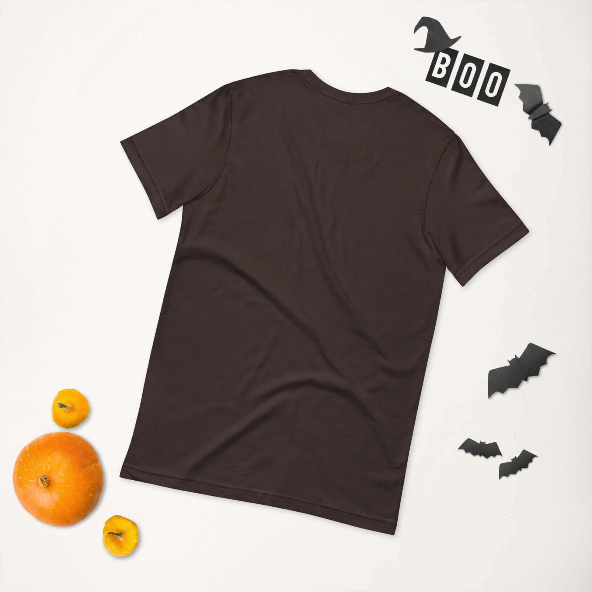 Black unisex t-shirt on a white background with Halloween decorations and pumpkins.