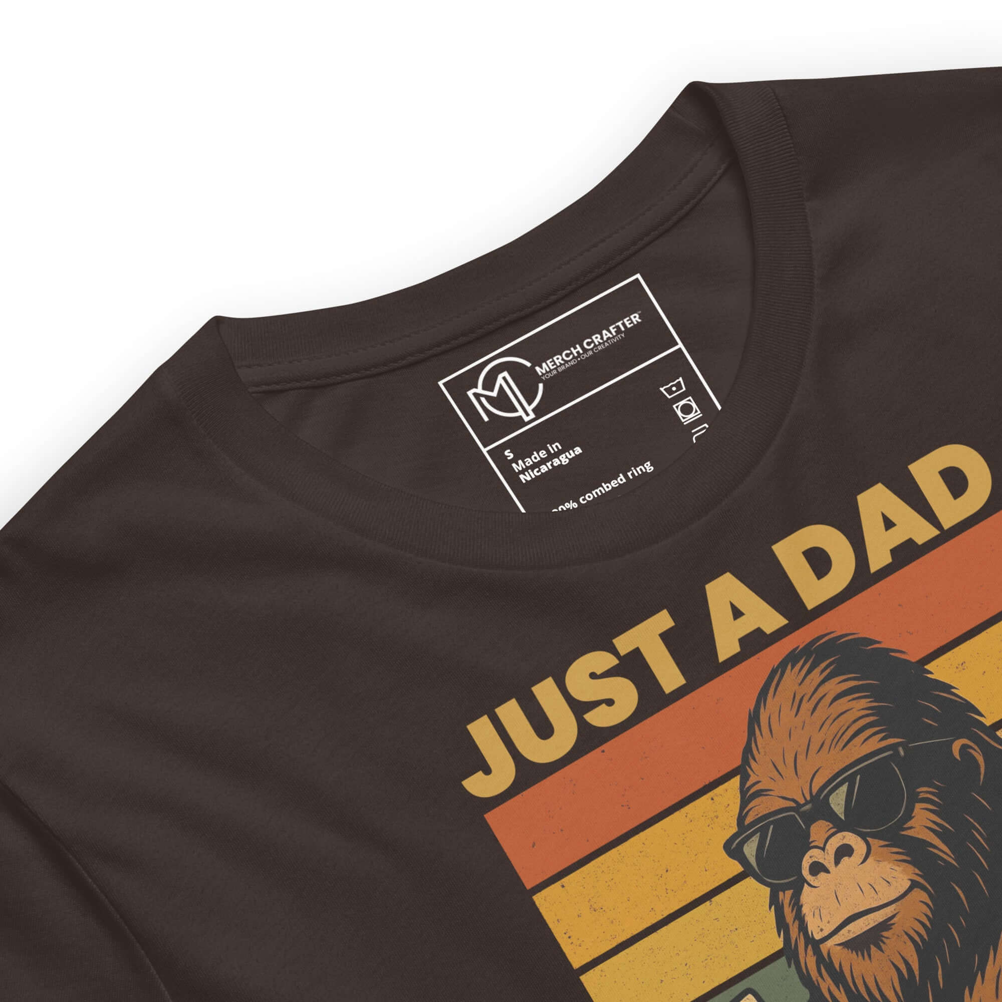 Bigfoot-themed dad t-shirt featuring design with sunglasses-wearing Sasquatch and vintage rainbow stripes.