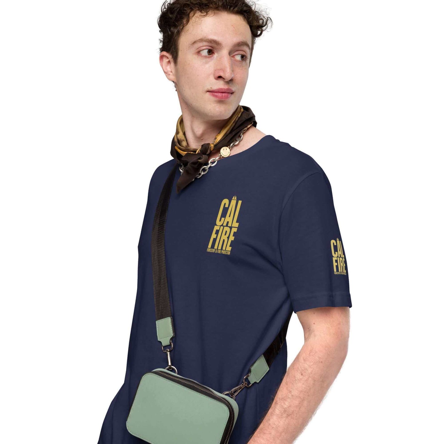 Cal Fire Forestry Firefighter T-Shirt, unisex design celebrating bravery, worn by male model with a green bag and scarf.