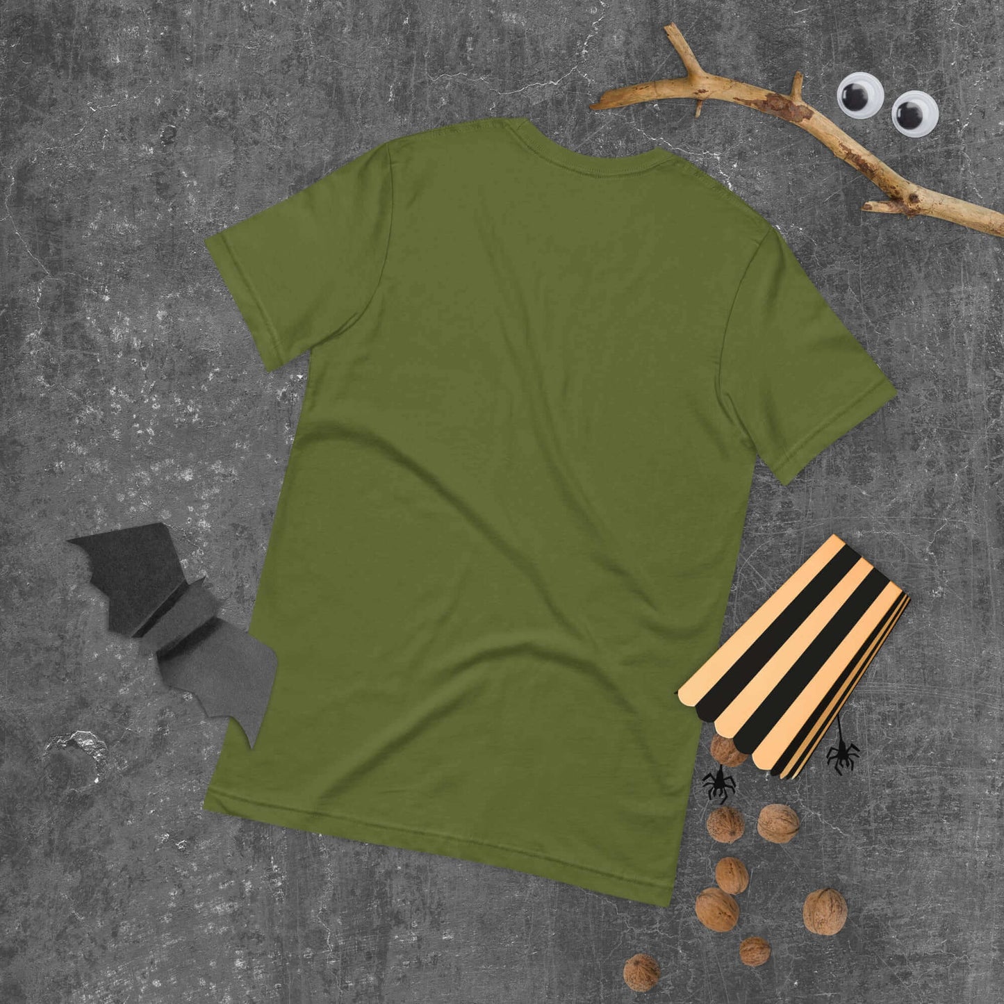 Green unisex t-shirt with Halloween-themed decorations on a grey background.