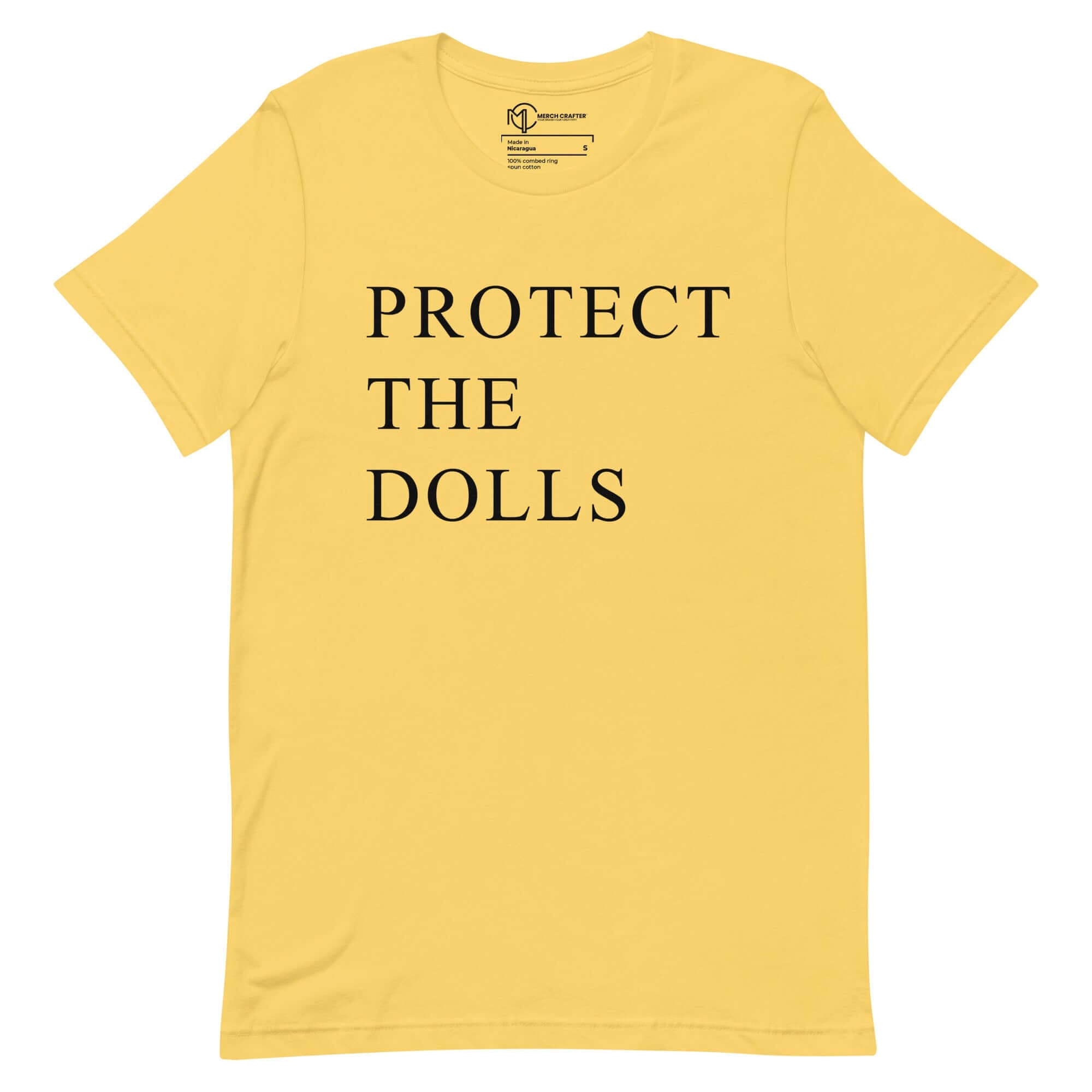 Unisex yellow t-shirt with bold text 'PROTECT THE DOLLS', promoting femininity and empowerment.